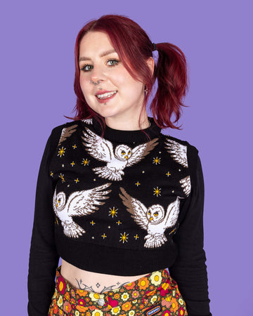 Close up of model wearing Owl Cropped tank. It has cute barn owls flying with yellow stars on a black background